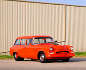 AUT 21 RK0167 04
1955 Orange Studebaker Conestoga Wagon 3/4 Side View On Pavement By Building