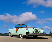 AUT 21 RK0235 04
1954 Light Green Cadillac Convertible 3/4 Rear View On Pavement Blue Sky Clouds