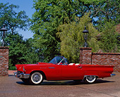 AUT 21 RK0271 03
1957 Ford Thunderbird E Type Red Convertible 3/4 Front View On Pavement By Brick Wall Trees