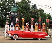 AUT 21 RK0277 05
1951 Red Lincoln Convertible Cosmopolitan Side View By Different Old Gas Pumps On Street Corner