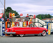 AUT 21 RK0281 01
1951 Red Lincoln Convertible Cosmopolitan 3/4 Rear View By Different Old Gas Pumps Gray Skies