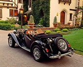 AUT 21 RK0288 06
1952 MG TD Convertible Black 3/4 Rear View On Driveway