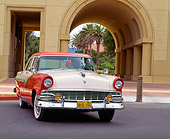AUT 21 RK0331 03
1956 Red And White Ford Fairlane Town Sedan 3/4 Front View On Pavement By Archways