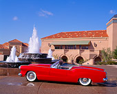 AUT 21 RK0348 05
1953 Red Plymouth Belmont Convertible Side View In Front Of Water Fountain Blue Sky