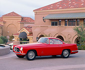AUT 21 RK0363 03
1957 Jaguar XK-140 Red 3/4 Front View On Pavement By Building