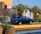 AUT 21 RK0385 02
1953 Black Fiat Ghia Coupe BV 3/4 Side View In Front Of Water Fountain Blue Sky