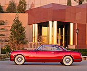 AUT 21 RK0389 01
1953 Burgundy Chrysler Sport Coupe Side View In Front Of Museum At Dusk