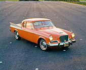 AUT 21 RK0399 04
1958 Orange Studebaker Commander Overhead 3/4 Front On Pavement Headlights On At Dusk