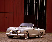 AUT 21 RK0408 11
1953 Gray Nash-Healey Roadster 3/4 Front View By Red Barn Headlights On