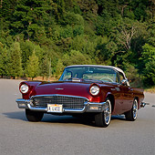 AUT 21 RK0438 06
1957 Ford Thunderbird Convertible Cinnamon 3/4 Front View On Pavement Trees Background