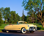 AUT 21 RK0445 04
1950 Yellow Hudson Commodore Convertible 3/4 Side View By Grass And Trees Blue Sky