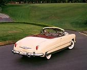 AUT 21 RK0455 01
1950 Hudson Commodore Convertible Yellow 3/4 Rear View On Pavement By Grass
