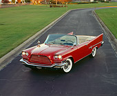 AUT 21 RK0494 02
1959 Chrysler 300E Convertible Red Overhead 3/4 Front View On Pavement By Grass Headlights On