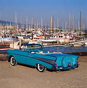 AUT 21 RK0595 01
1957 Chevrolet Bel Air Convertible Light Blue 3/4 Rear View On Gravel By Harbor Blue Sky