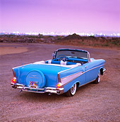 AUT 21 RK0603 04
1957 Chevrolet Bel Air Convertible Light Blue Overhead 3/4 Rear View On Dirt City Lights At Night