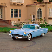 AUT 21 RK0626 07
1957 Ford Thunderbird Powder Blue 3/4 Side View On Pavement In Front Of House Headlights On