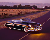 AUT 21 RK0645 04
1953 Chevrolet Bel Air Convertible Black 3/4 Front View On Road At Dusk By Hay Field