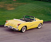 AUT 21 RK0671 03
1954 Buick Skylark Model 100 Convertible Yellow 3/4 Rear Overhead On Pavement By Grass