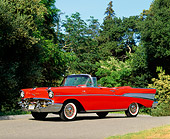 AUT 21 RK0676 09
1957 Chevy Bel Air Fuel Injection Convertible Red 3/4 Side View On Pavement By Trees Blue Sky
