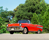 AUT 21 RK0677 03
1957 Chevy Bel Air Fuel Injection Convertible Red Low 3/4 Front View On Pavement By Trees Blue Sky