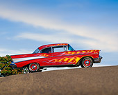AUT 21 RK0710 04
1957 Chevrolet Bel Air Red With Flames Slanted Side View On Pavement Blue Sky