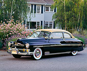 AUT 21 RK0732 01
1950 Mercury Monterey Black Convertible 3/4 Side View On Pavement By House Trees And Flowers