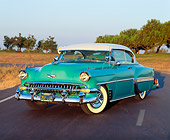 AUT 21 RK0753 02
1954 Chevrolet Bel Air Turquoise 3/4 Front View On Road Dry Grass And Trees At Dusk