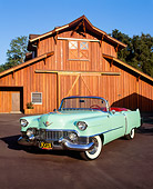 AUT 21 RK0812 05
1954 Cadillac Convertible Light Green 3/4 Front View On Pavement By Wooden Barn Blue Sky