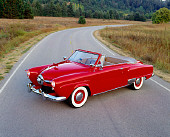 AUT 21 RK0814 07
1950 Studebaker Convertible Red Overhead 3/4 Side View On Road Headlights On By Dry Grass And Trees