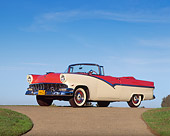 AUT 21 RK0825 08
1956 Ford Fairlane Sunliner Convertible Red & White Low 3/4 Side View On Pavement By Grass Blue Sky