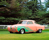 AUT 21 RK0828 03
1951 Studebaker Pro Street Peach And Green 3/4 Side View On Grass By Trees And Fence Parking Lights On