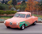 AUT 21 RK0832 04
1951 Studebaker Street Rod Peach And Green 3/4 Front View On Pavement By Trees And Flowers Headlights On