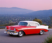 AUT 21 RK0839 09
1956 Chevy Bel Air Red And White 3/4 Side View On Pavement Mountains Background At Dusk