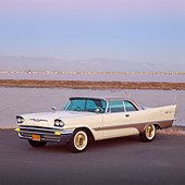 AUT 21 RK0887 01
1957 Desoto Adventurer White Side 3/4 View On Pavement By Water Parking Lights On At Dusk