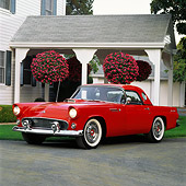 AUT 21 RK0888 02
1955 Ford Thunderbird Red Front 3/4 View On Pavement In Front Of House Headlights On