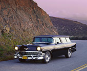 AUT 21 RK0921 02
1956 Chevy Nomad Wagon Black 3/4 Front View On Road Headlights On Side Of Hill Purple Sky