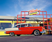 AUT 21 RK0922 03
1955 Chevy Bel Air Red And White Low 3/4 Side View On Pavement In Front Of Taxis