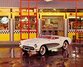 AUT 21 RK0923 01
1957 Chevrolet Corvette Convertible White And Silver 3/4 Front View On Wet Pavement By Diner