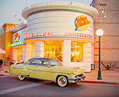 AUT 21 RK0946 05
1954 Mercury Monterey Sun Valley Yellow 3/4 Side View Headlights On Road By Diner At Dusk