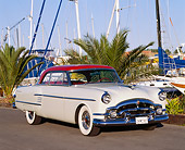 AUT 21 RK0950 02
1954 Packard Pacific Red And White 3/4 Front View On Pavement By Harbor Blue Sky