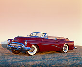 AUT 21 RK0978 02
1953 Buick Skylark Convertible Burgundy 3/4 Side View On Pavement Orange Wall Background At Dusk
