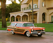 AUT 21 RK1024 03
1957 Mercury Colony Park Station Wagon Orange 3/4 Front View On Pavement Headlights On By Building