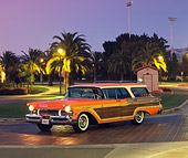 AUT 21 RK1026 04
1957 Mercury Colony Park Station Wagon Orange 3/4 Side View Headlights On By Trees Purple Sky At Night