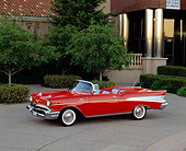AUT 21 RK1057 06
1957 Chevy Bel Air Convertible Fuel Injection Red 3/4 Side View On Pavement By Building And Trees