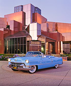AUT 21 RK1072 01
1955 Cadillac Convertible Blue 3/4 Front View On Pavement By Lighted Building At Dusk