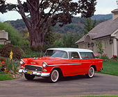 AUT 21 RK1097 01
1955 Chevy Nomad Wagon Red White Top 3/4 Front View On Pavement By Flowers And Trees