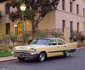 AUT 21 RK1110 03
1957 Desoto Firesweep Yellow And Green 3/4 Front View On Pavement By Building And Flowers