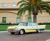 AUT 21 RK1113 03
1957 Desoto Firesweep Yellow And Green 3/4 Side View On Driveway By Palm Tree And Building