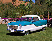 AUT 21 RK1141 01
1958 Nash Metropolitan Blue And White 3/4 Side View On Grass By Trees