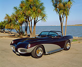 AUT 21 RK1147 01
1952 LaDawri Conquest Convertible Gray And Black Front 3/4 View On Pavement By Palm Trees And Water